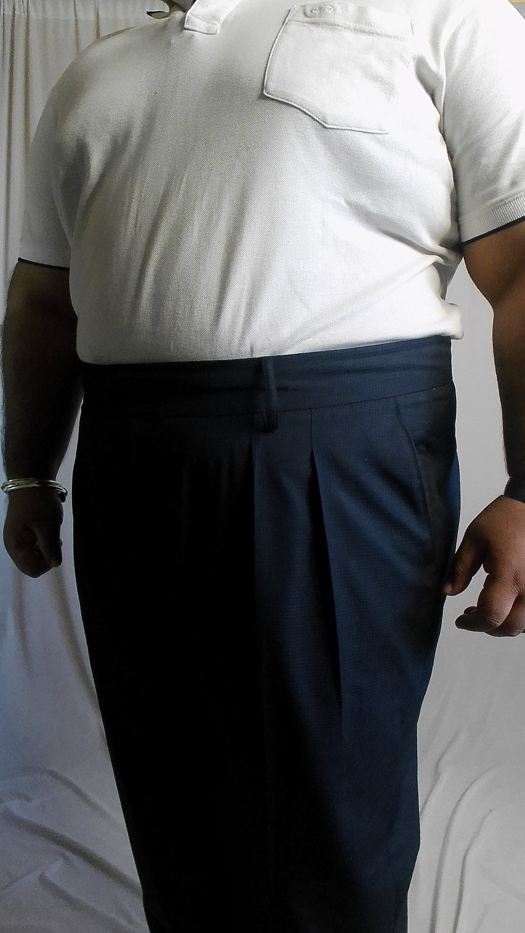 Person wearing a white shirt and dark navy pants on a light background