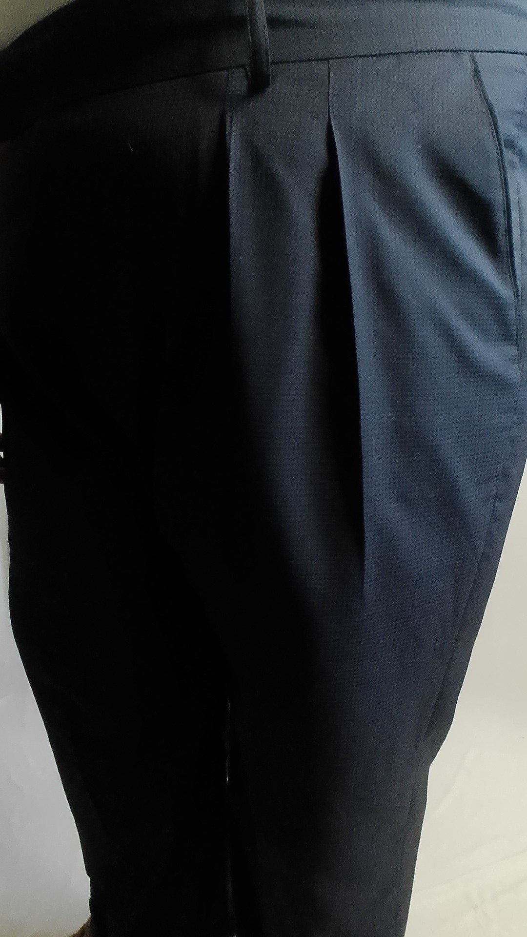 Close-up of forward pleats on a Navy Blue Trouser