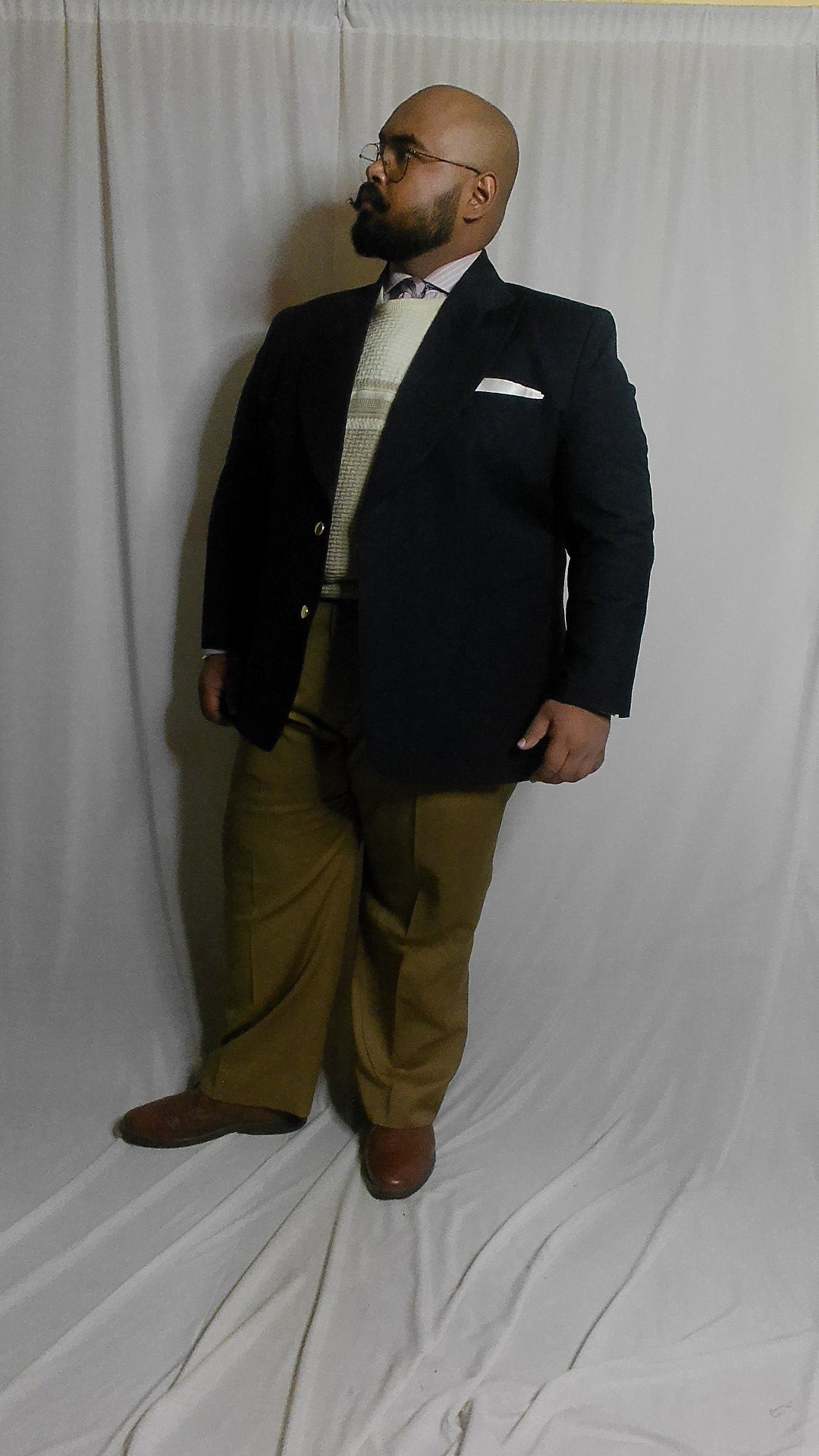 Navy blazer layered with a crew neck sweater