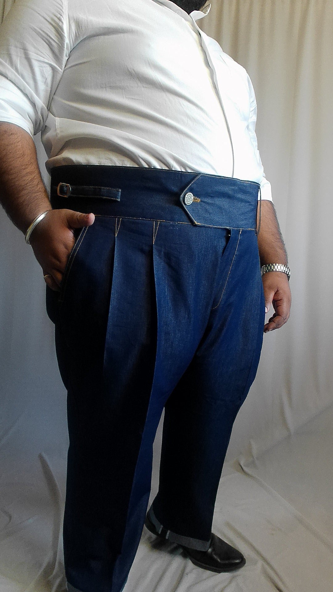 Person wearing a white shirt and blue denim trouser 
