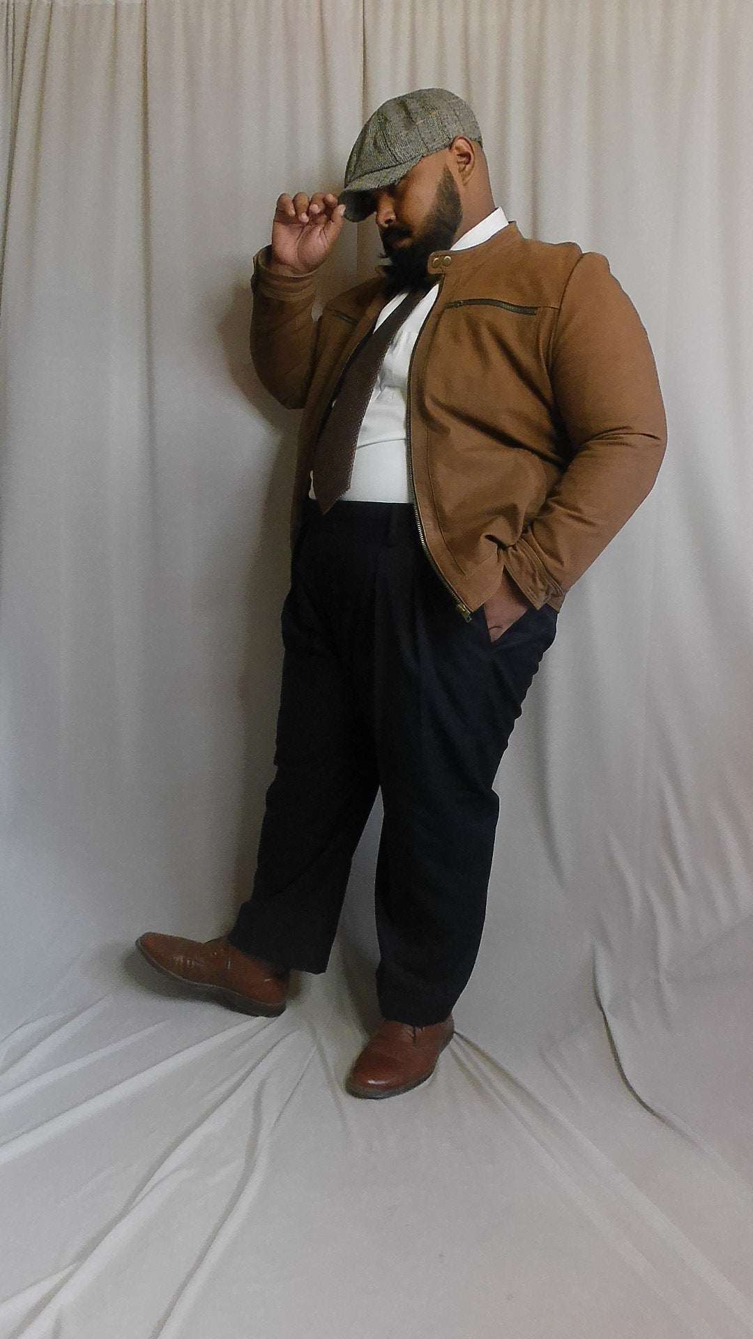 Person wearing a brown jacket and Super 140 Navy Blue Pants 